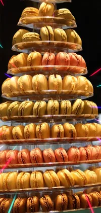 This phone live wallpaper features a tower of delicious macaroons sitting on a table