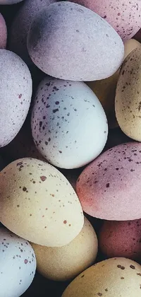 This phone live wallpaper showcases a pile of speckled eggs in pastel shades of pink, blue, and yellow, arranged on top of each other