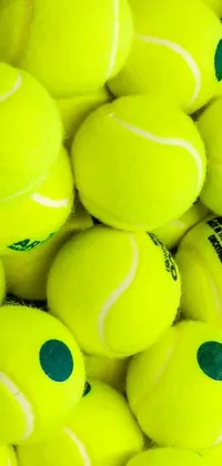 This live phone wallpaper depicts a fun pile of tennis balls in vibrant shades of yellow
