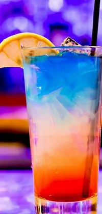 This live wallpaper features a colorful drink, complete with a lemon wedge resting on the rim and a straw in the glass, set against a vibrant purple background