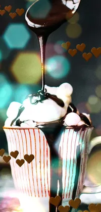 Enjoy a deliciously indulgent live wallpaper featuring chocolate sauce drizzling over a hot cup of cocoa