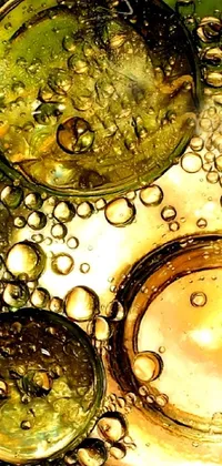 Get a mesmerizing live wallpaper for your phone! Make your screen come alive with a stunning macro photograph of bubbles in a bowl of water