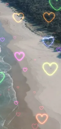 This phone live wallpaper features a beach scene filled with colorful hearts that come in a variety of shades and sizes, adding a playful and romantic touch to the ambiance