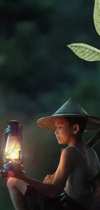 This phone live wallpaper depicts a little boy sitting with a lantern in hand in a picturesque jungle landscape