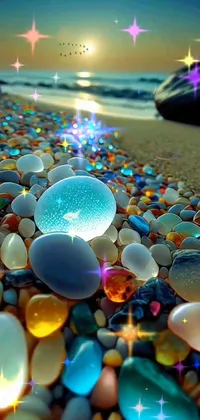 Looking for a stunning phone live wallpaper? Look no further! This composition showcases a group of multicolored stones sitting on a serene beach
