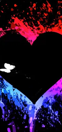 This phone live wallpaper features a realistic heart with paint splatters on it set against a black background