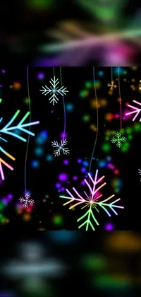 Download Snowflakes Live Wallpaper and enhance your phone's appearance with this digital rendering of a bunch of snowflakes hanging from strings, against a black background