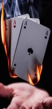 This dynamic live wallpaper is perfect for your phone! It features a hand holding four of a kind playing cards that are highly detailed and realistic
