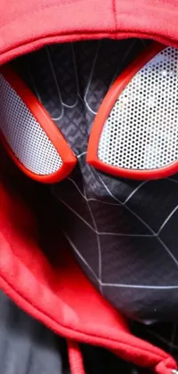 This smartphone live wallpaper showcases a close-up of a Spider-Man mask, featuring intricate red and black details and 8k fabric textures