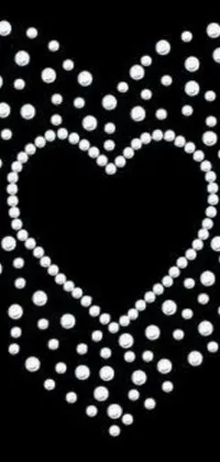 This phone live wallpaper is a sophisticated creation that portrays a heart-shaped design made of pearls against a black background