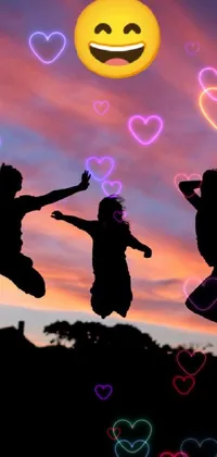 This live wallpaper features three individuals joyfully jumping in front of a striking sunset