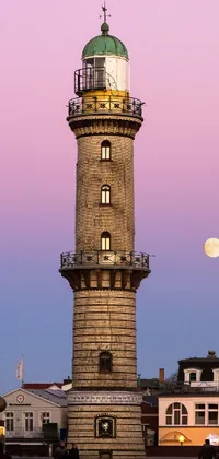 This vertical live wallpaper showcases a French architecture with a lighthouse and a giant pink full moon