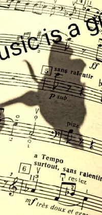This phone live wallpaper showcases a fascinating shadow of a figure on a musical sheet