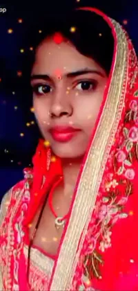 This beautiful live wallpaper features an image of a confident woman wearing a vibrant red sari, posing in front of a camera