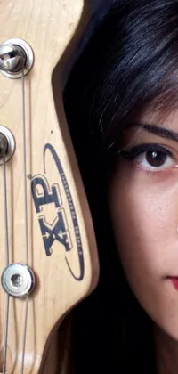 This mesmerizing phone live wallpaper features a close-up of a person holding a guitar