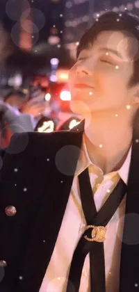 This phone live wallpaper showcases a sophisticated man in a refined suit and tie, posing for a selfie