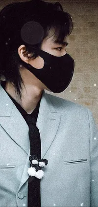 This phone live wallpaper features a close-up of a person wearing a face mask