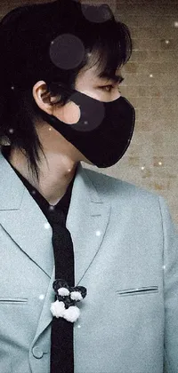 This phone wallpaper displays a striking close-up of a person wearing a face mask against a black background