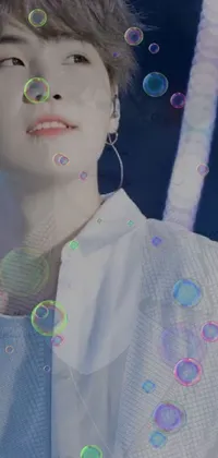 This phone live wallpaper showcases a fascinating image of a man amidst colorful bubbles