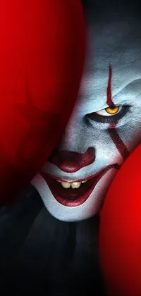 This phone live wallpaper features a digital art portrait of a famous horror clown, with a repeating penny background