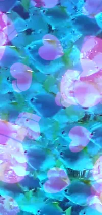 This live wallpaper features a digital art of swimming fish that incorporates glitter, seaglass elements, and vibrant dayglo colors: pink and blue
