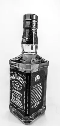 This black and white Jack Daniels Phone Live Wallpaper boasts a striking portrait mode photo featuring an iconic bottle of the famous whiskey set against a black 3D cuboid device set atop a white background