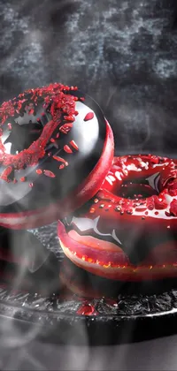 This live phone wallpaper features two neon-colored donuts with sprinkles in shades of red and black