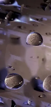 This live wallpaper features a close-up of water droplets on a surface