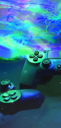 This is a live phone wallpaper featuring two video game controllers, swirling bioluminescent energy, and a playstation 4 symbol
