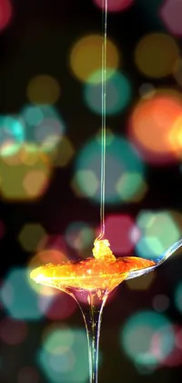 This unique live wallpaper features a highly detailed spoon filled with small particles of food visible under a microscopic photo