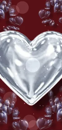 This live wallpaper features a silver heart surrounded by smaller hearts on a red background, a sparkling crystal material design perfect for anyone looking for a romantic aesthetic on their phone's home screen