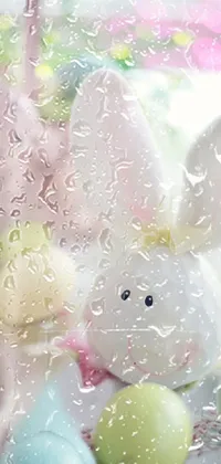This phone live wallpaper features a colorful Easter-themed scene on a table top