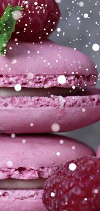 This phone live wallpaper depicts a mouth-watering image of raspberry macarons stacked in pastel hues, accented with refreshing mint highlights