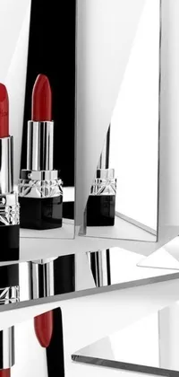 Discover a stunning live wallpaper featuring a luscious red lipstick placed on a table next to a mirror