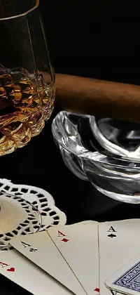 This attractive live wallpaper showcases a stunning still life featuring a glass of whiskey, playing cards, and a cigar