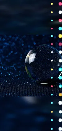 This phone live wallpaper showcases a glass ball on a picture table, complemented by a blue background and glitter gif