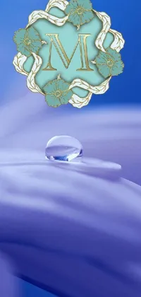 This phone live wallpaper features a stunning image of a water droplet sitting on a flower