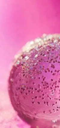 This phone live wallpaper is a beautiful and artistic composition that features a close-up image of a glass ball on a table