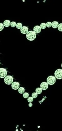 This phone live wallpaper is a vibrant heart composed entirely of dazzling diamond bling set against a sleek black background, accented with hints of light green