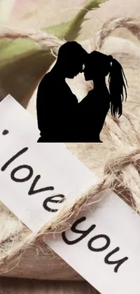 This live phone wallpaper showcases a couple sharing a loving kiss in front of a "I Love You" sign