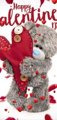 This adorable live wallpaper for your phone boasts a charming felt-like animation of a cuddly teddy bear holding a heart with the message "Happy Valentine's Day"