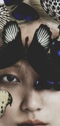 This live phone wallpaper features a stunning woman with colorful butterflies on her head