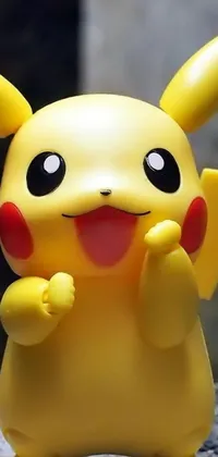 This phone wallpaper features an adorable Pikachu toy closely captured with an excited expression
