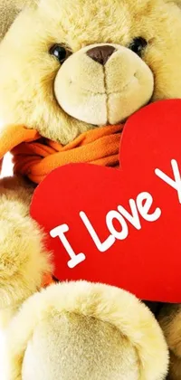 This phone live wallpaper features an adorable teddy bear holding a red heart with "I love you" written in bold letters