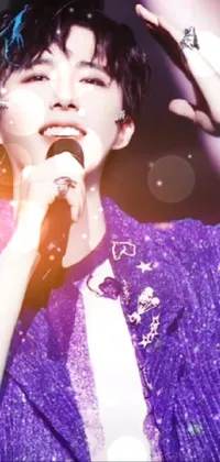 This phone live wallpaper portrays a person holding a microphone and performing on stage, with a focus on the vibrant purple vest