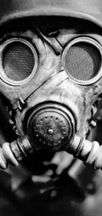 This live phone wallpaper showcases a dramatic black and white photo featuring a gas mask-wearing man, creating an ominous and post-apocalyptic atmosphere