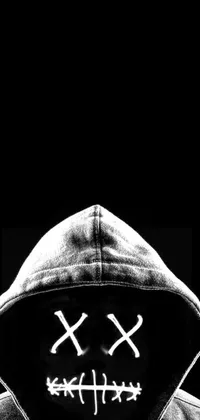 Get the best minimalist phone wallpaper featuring a black and white photo of a hooded figure with a striking X logo atop