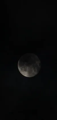 This live phone wallpaper features a beautiful depiction of the moon in a dark sky