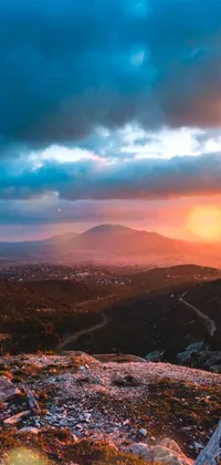 This phone live wallpaper displays a vibrant sunset from a mountain peak, with Athens in the background