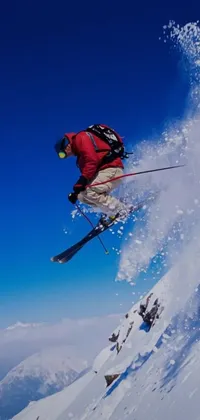 Looking for an exciting wallpaper for your phone? Look no further than this dynamic live wallpaper! It features a man riding skis through the air, with striking colors and details